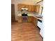 Open kitchen with laminate floors, wood cabinets, white countertops, and stainless steel appliances at 39 Meadow Creek East Blvd, Whiteland, IN 46184