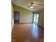Bright living room with ceiling fan, laminate flooring, and sliding glass door at 39 Meadow Creek East Blvd, Whiteland, IN 46184