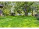 Backyard featuring a lush grassy lawn, mature trees, and a wooden shed at 436 N 500 W, Anderson, IN 46011