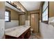 Bathroom features a sink, mirror, toilet, and flower art on the doors at 436 N 500 W, Anderson, IN 46011