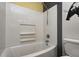 Bathroom features a tub and shower with a white tile surround at 436 N 500 W, Anderson, IN 46011