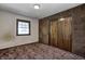 Bedroom features a window, carpet, and a closet with sliding doors at 436 N 500 W, Anderson, IN 46011