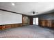 Living room featuring wood paneling, a projector screen, and a sliding glass door at 436 N 500 W, Anderson, IN 46011