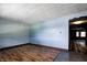 Spacious living room featuring wood-look flooring, blue walls, and an open doorway at 436 N 500 W, Anderson, IN 46011