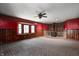 Spacious living room featuring a brick fireplace, ceiling fan, and bay windows at 436 N 500 W, Anderson, IN 46011