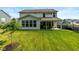 Expansive backyard features lush green grass, covered patio, and views of the home's rear facade at 4642 Boyd Pl, Westfield, IN 46062