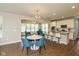 Open-concept dining area with modern table and chairs, seamlessly connected to the kitchen and living spaces at 4642 Boyd Pl, Westfield, IN 46062