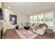 Comfortable living room featuring a cozy fireplace, large sectional sofa, and natural light at 4642 Boyd Pl, Westfield, IN 46062