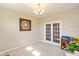 Bright living room featuring neutral walls, plush carpet, French doors, and stylish light fixture at 4642 Boyd Pl, Westfield, IN 46062