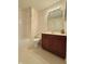 Cozy bathroom featuring a combination tub/shower, wood vanity, and tiled flooring at 5019 Amber Creek Pl, Indianapolis, IN 46237