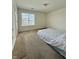 Bare bedroom with neutral walls, with a light-filled room from the large window at 5019 Amber Creek Pl, Indianapolis, IN 46237