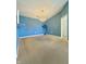 Open dining room with blue walls, chandelier, and doorway entrance view at 5019 Amber Creek Pl, Indianapolis, IN 46237