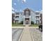 Charming condo building with brick and siding, featuring a well-maintained lawn and convenient parking at 5019 Amber Creek Pl, Indianapolis, IN 46237