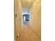 Inviting hallway with hardwood floors leading to a brightly lit living space with a blue accent wall at 5019 Amber Creek Pl, Indianapolis, IN 46237