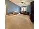 Inviting living room with blue walls, carpeted floors, and a ceiling fan at 5019 Amber Creek Pl, Indianapolis, IN 46237