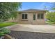 Brick home featuring a concrete patio with well-maintained landscaping and a door leading inside at 5274 Brooks Bnd, Greenwood, IN 46143