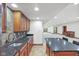 Basement kitchenette with granite counters and stone backsplash with nearby carpeted room at 5274 Brooks Bnd, Greenwood, IN 46143
