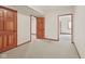 Basement with neutral carpeting and wood trim, with three doors leading to other spaces at 5274 Brooks Bnd, Greenwood, IN 46143