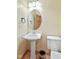 Cozy bathroom featuring a pedestal sink, toilet, oval mirror, and bronze fixtures at 5274 Brooks Bnd, Greenwood, IN 46143