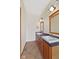 Bathroom featuring double sink vanity with dark countertops and updated lighting fixtures at 5274 Brooks Bnd, Greenwood, IN 46143