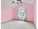 Bedroom with pink walls has a large arched window with decorative curtains and a ceiling fan at 5274 Brooks Bnd, Greenwood, IN 46143