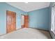 A bright bedroom with neutral carpet and three wood doors is ready for your personal touch at 5274 Brooks Bnd, Greenwood, IN 46143