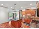 Well-lit kitchen featuring a center island, stainless steel appliances, and wooden floors at 5274 Brooks Bnd, Greenwood, IN 46143