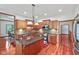 Modern kitchen with wooden cabinets, a kitchen island, and modern appliances at 5274 Brooks Bnd, Greenwood, IN 46143