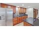 Basement kitchenette with granite counters and stainless steel refrigerator located near the stairs at 5274 Brooks Bnd, Greenwood, IN 46143