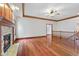 Open-concept living room with hardwood floors, a fireplace, and staircase access at 5274 Brooks Bnd, Greenwood, IN 46143