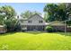 Lush backyard featuring mature trees and an outdoor dining area at 54 Horseshoe Ln, Carmel, IN 46033