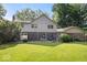 Expansive backyard featuring lush lawn, mature trees, and an outdoor dining area at 54 Horseshoe Ln, Carmel, IN 46033