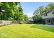Spacious backyard featuring a lush lawn, plantings, and a fenced perimeter at 54 Horseshoe Ln, Carmel, IN 46033