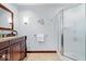Bathroom featuring a wood vanity with granite top and a glass-enclosed shower at 54 Horseshoe Ln, Carmel, IN 46033
