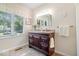 Bathroom featuring a dark wood vanity with granite countertops, sink, and faucet at 54 Horseshoe Ln, Carmel, IN 46033