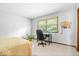 Bedroom featuring a desk, chair, and green house plant at 54 Horseshoe Ln, Carmel, IN 46033