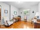 Bright bedroom with hardwood floors, a desk area, and plenty of natural light at 54 Horseshoe Ln, Carmel, IN 46033