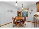 Eat-in kitchen with wooden table, chairs, and a corner cabinet for storage at 54 Horseshoe Ln, Carmel, IN 46033