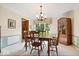 Classic dining room with hardwood chairs, table, and window with floral valance at 54 Horseshoe Ln, Carmel, IN 46033
