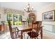 Sunlit dining room with wooden furniture, large windows, and classic decor at 54 Horseshoe Ln, Carmel, IN 46033