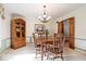 Traditional dining room featuring wood furnishings, a display cabinet, and soft lighting at 54 Horseshoe Ln, Carmel, IN 46033