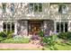 Up close view of the beautiful front entrance with lovely brickwork and luscious greenery at 54 Horseshoe Ln, Carmel, IN 46033
