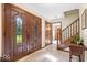 Elegant foyer with hardwood floors, decorative glass doors, and staircase at 54 Horseshoe Ln, Carmel, IN 46033