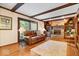 Warm Gathering room with a brick fireplace, hardwood floors, and exposed wood beams at 54 Horseshoe Ln, Carmel, IN 46033