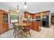 Bright eat-in kitchen with wood cabinets, black appliances, and a cozy dining area at 54 Horseshoe Ln, Carmel, IN 46033