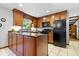 Well-lit kitchen with wood cabinets, modern appliances, and a functional island layout at 54 Horseshoe Ln, Carmel, IN 46033