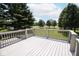Back deck with lush green lawn and trees beyond at 5707 In-234, McCordsville, IN 46055