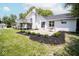 Spacious backyard featuring a raised deck, patio, landscaping, and a porch swing at 5707 In-234, McCordsville, IN 46055