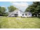 Spacious backyard featuring a raised deck, patio, landscaping, and a fire pit at 5707 In-234, McCordsville, IN 46055