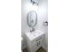 Modern bathroom featuring a sleek vanity, oval mirror, modern lighting, and black hardware at 5707 In-234, McCordsville, IN 46055